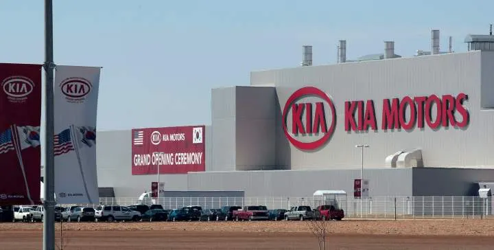 Vehicles sit outside the first U.S. Kia automobile manufacturing facility during its grand opening in West Point, Georgia, U.S., on Friday, Feb. 26, 2010.