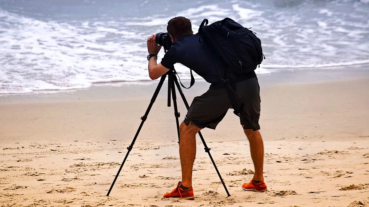 professional digital video or movie camera with microphone on tripod